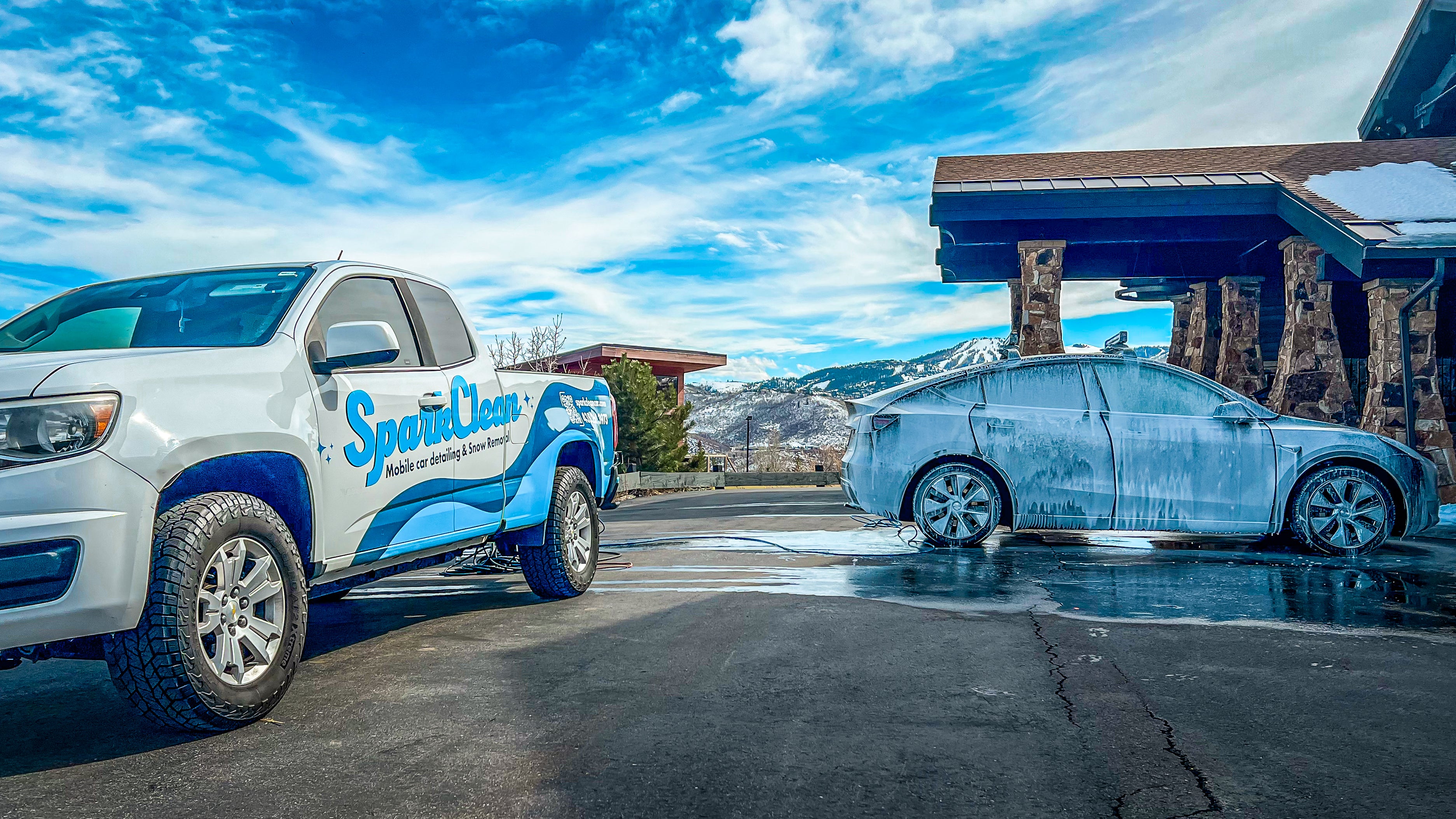 SparkClean truck providing mobile car detailing with foam wash in a Park City driveway